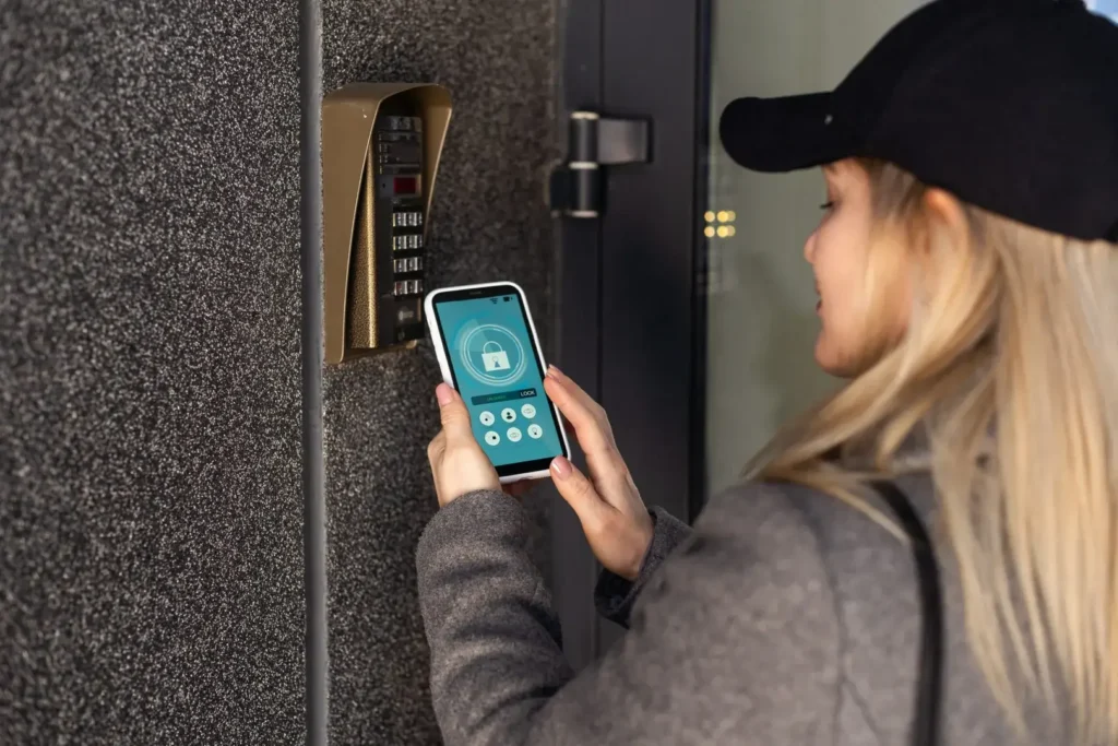 woman uses smartphone to open the door of his hous 2024 10 03 19 12 10 utc scaled (1)